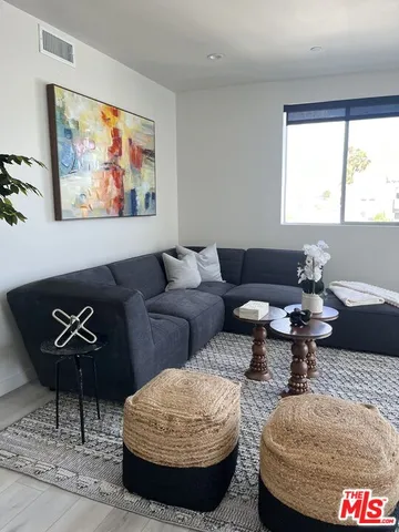 a living room with furniture and a rug