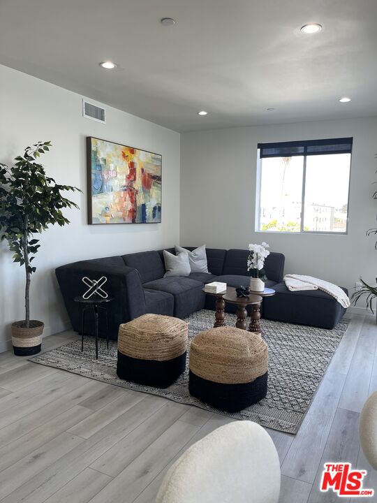 124 South Croft Avenue, Unit 403 Los Angeles, CA 90048 - Photo 24 of 31 a living room with furniture and a large window