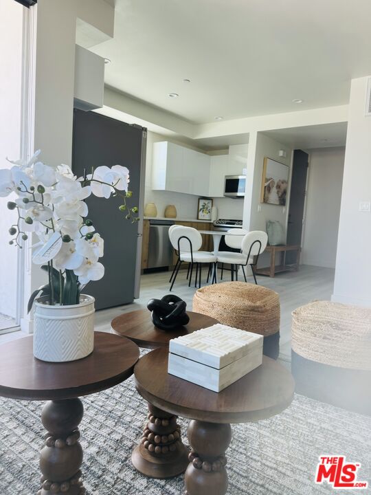 124 South Croft Avenue, Unit 403 Los Angeles, CA 90048 - Photo 28 of 31 a living room with furniture and wooden floor