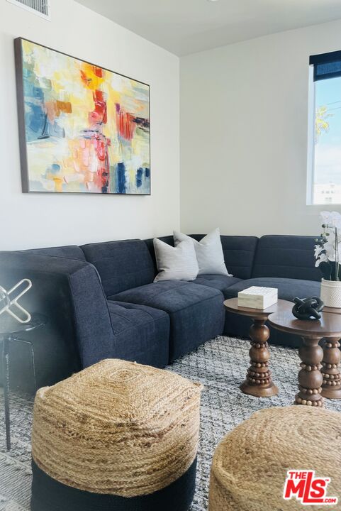 124 South Croft Avenue, Unit 403 Los Angeles, CA 90048 - Photo 29 of 31 a living room with furniture and a rug
