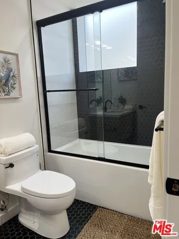 a bathroom with a toilet a sink and a shower