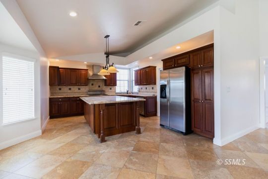 919 Beverly Court Ridgecrest, CA 93555 - Photo 11 of 29 a kitchen with a refrigerator and a sink