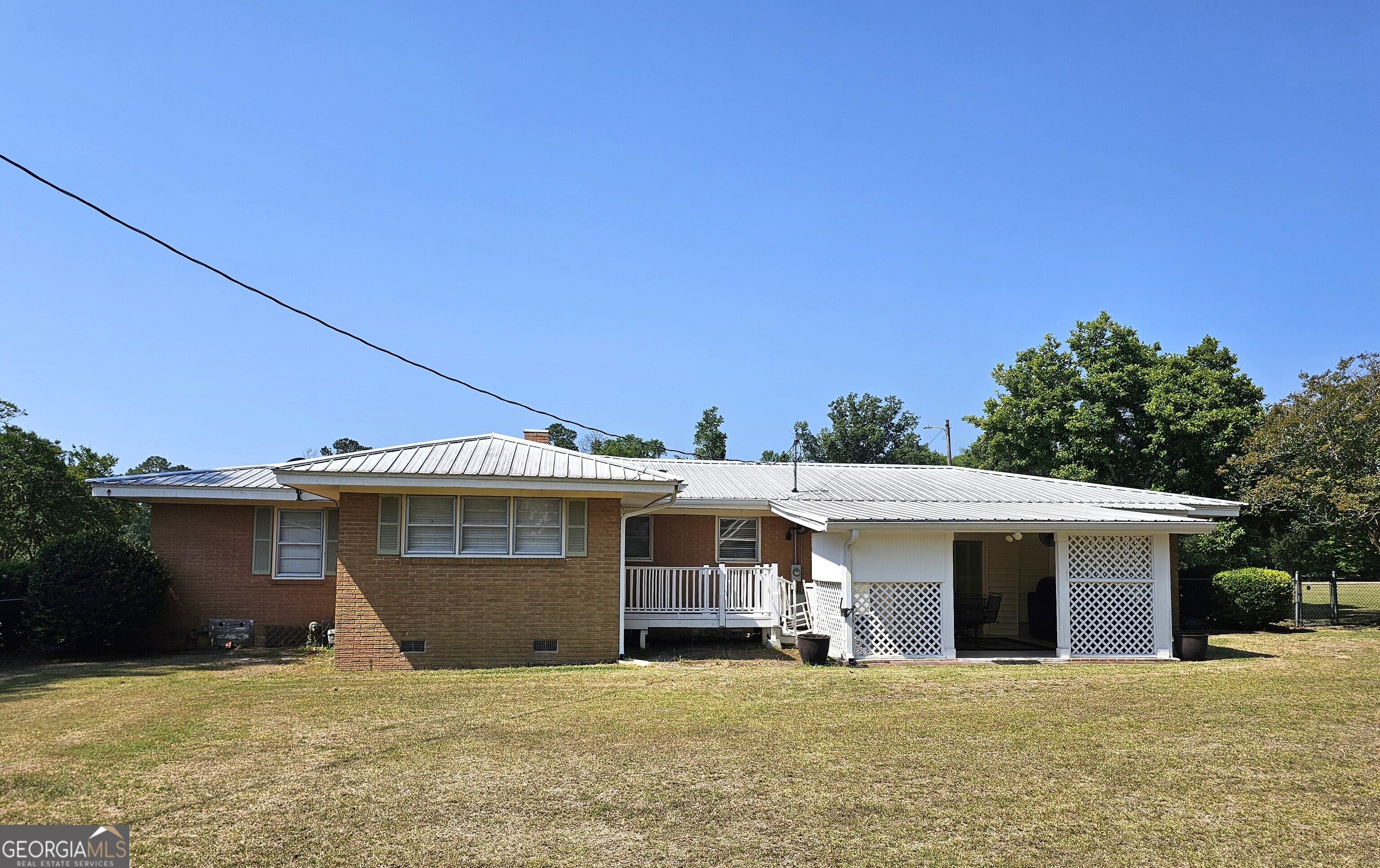 1853 Highway 441 Dublin, GA 31021 - Photo 25 of 28 a view of a house with a big yard and a large tree
