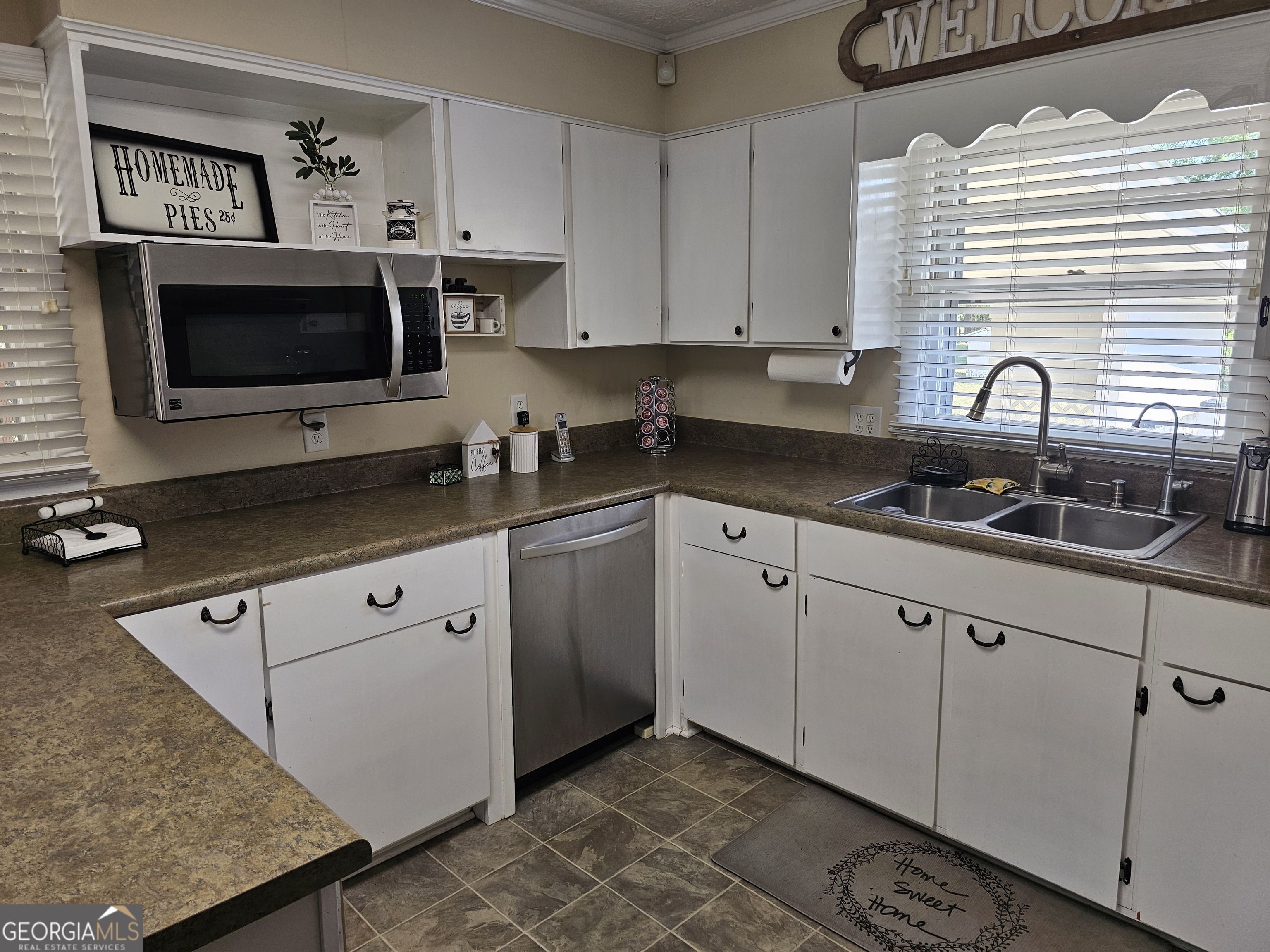 1853 Highway 441 Dublin, GA 31021 - Photo 5 of 28 a kitchen with stainless steel appliances granite countertop a sink a stove and a microwave