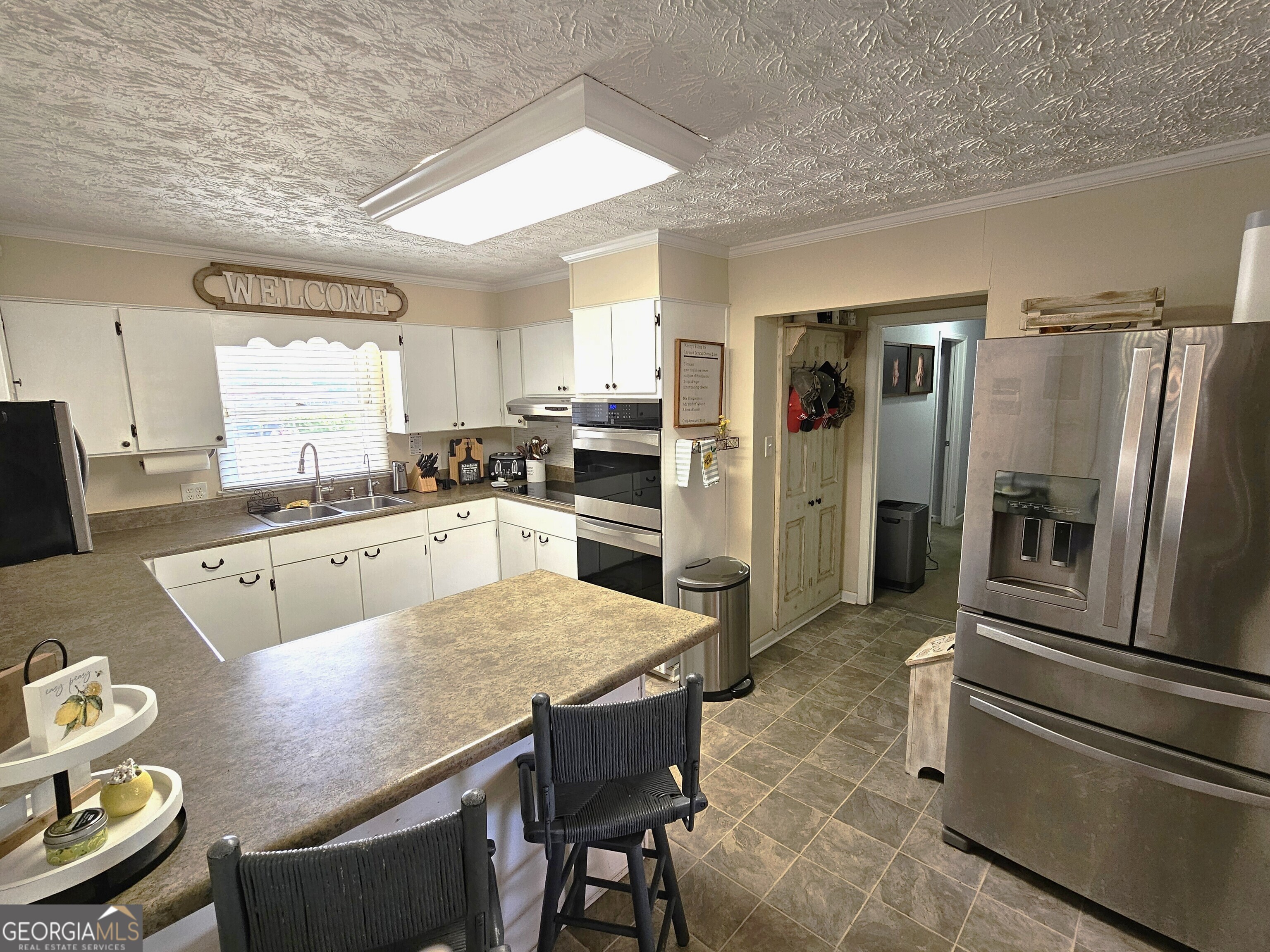 1853 Highway 441 Dublin, GA 31021 - Photo 7 of 28 a large kitchen with kitchen island a large counter top stainless steel appliances and cabinets