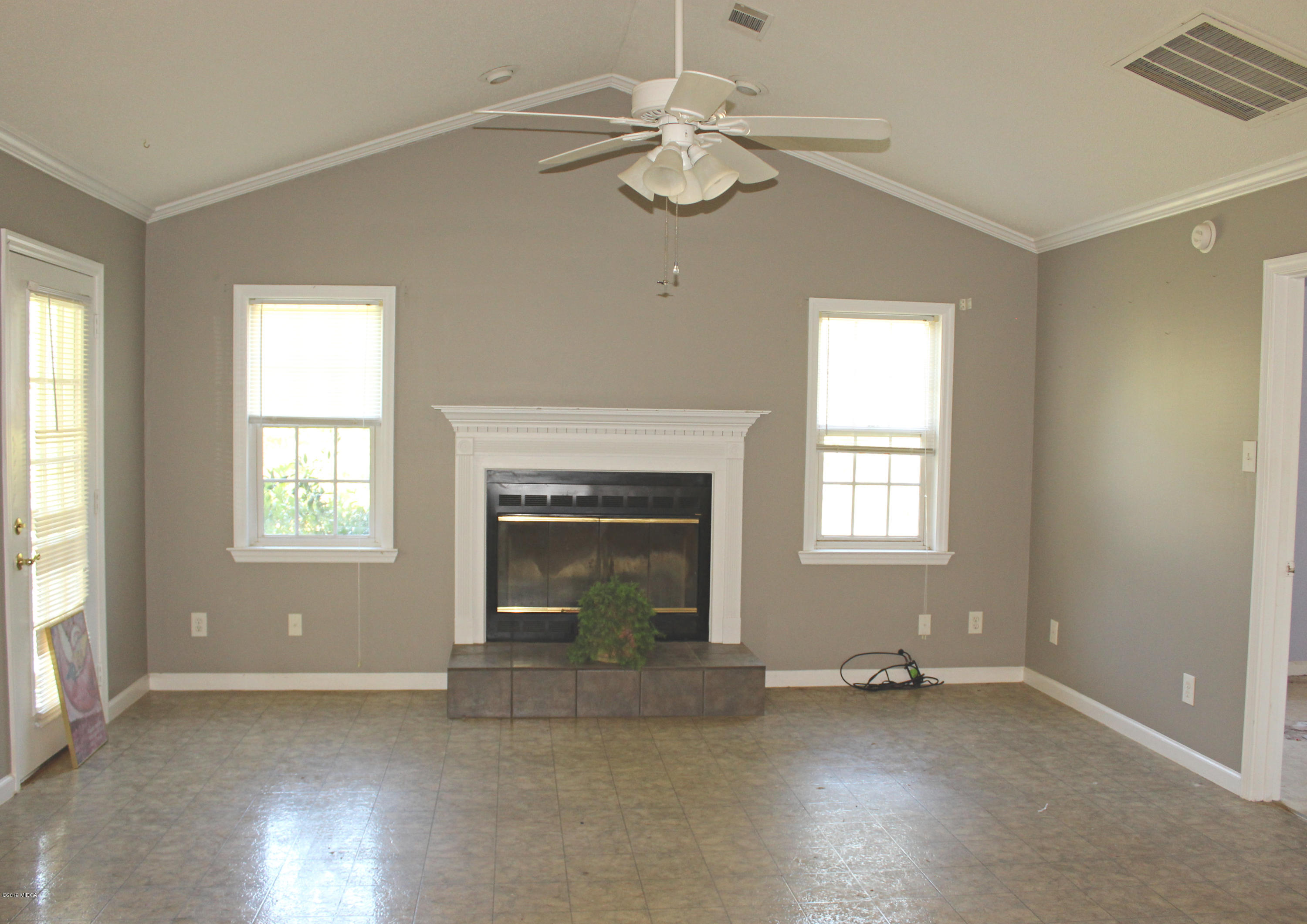 1888 Boxankle Road Forsyth, GA 31029 - Photo 2 of 6 wooden floor fireplace and windows in an empty room