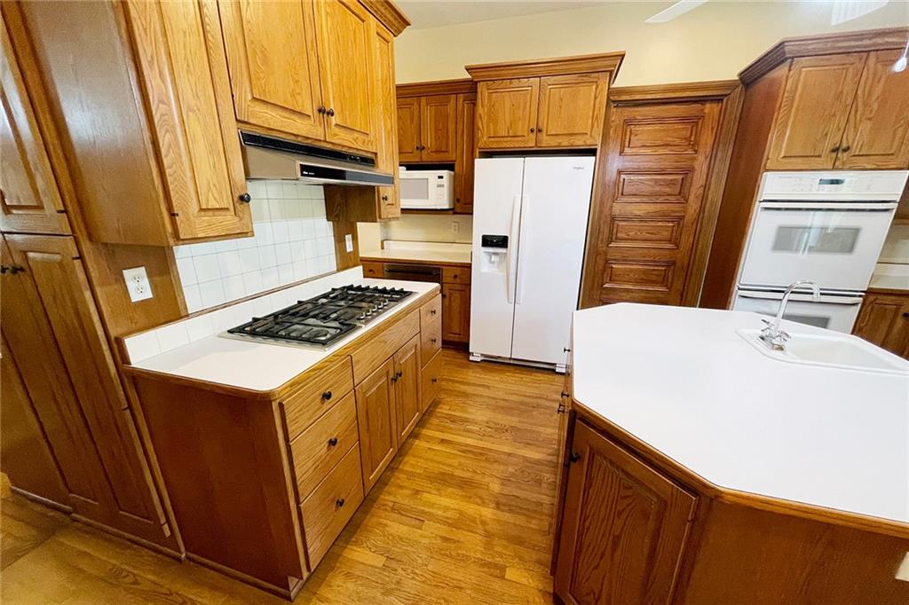 403 Laughlin Street Dawson, PA 15428 - Photo 14 of 39 a kitchen with a sink a refrigerator and cabinets