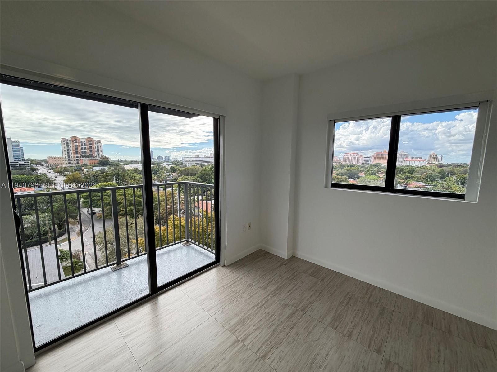 1801 Southwest 32nd Avenue, Unit 704 Miami, FL 33145 - Photo 11 of 18 a view of empty room with wooden floor and fan