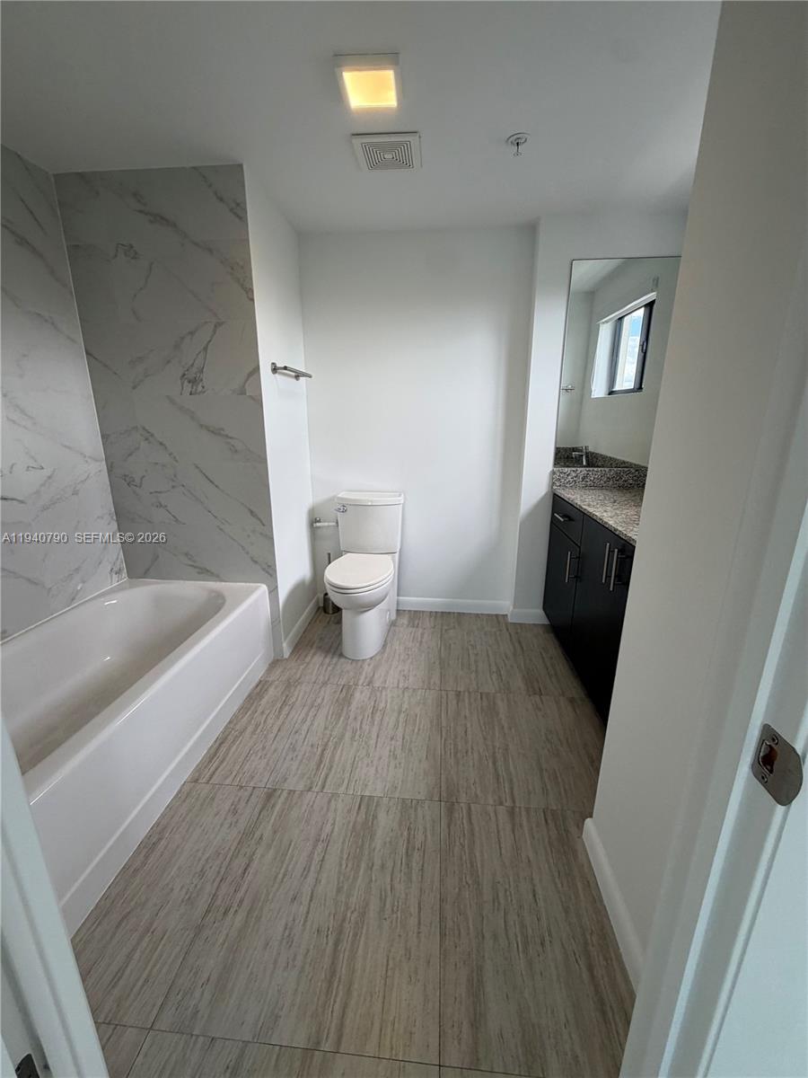 1801 Southwest 32nd Avenue, Unit 704 Miami, FL 33145 - Photo 12 of 18 a bathroom with a sink and a toilet