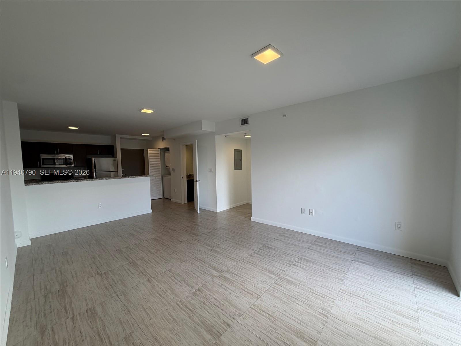 1801 Southwest 32nd Avenue, Unit 704 Miami, FL 33145 - Photo 8 of 18 a view of a kitchen with a refrigerator and a stove top oven