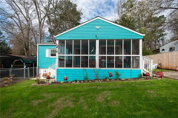 a front view of a house with a yard table and chairs