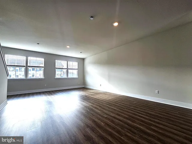 a view of a room with wooden floor and a window