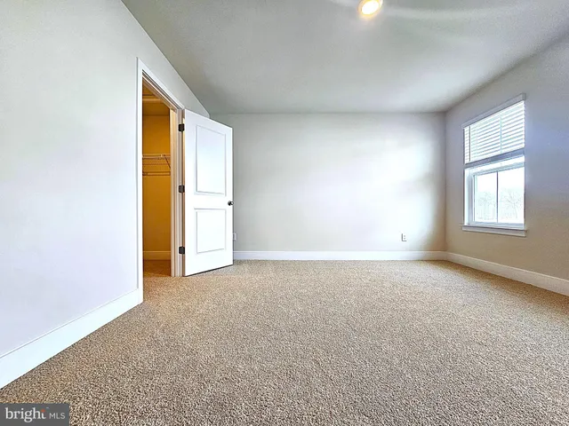 a view of an empty room and a window