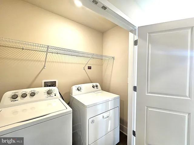 a bathroom with a granite countertop sink a toilet a mirror and bathtub