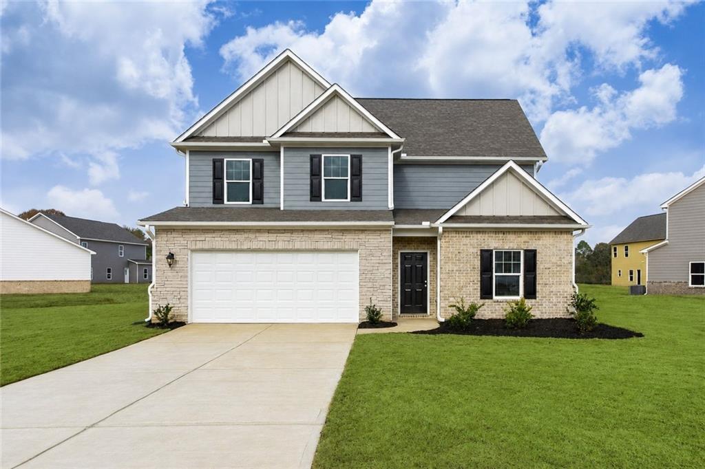 631 Meadows Farm Way Monroe, GA 30655 - Photo 1 of 1 a front view of a house with a yard and garage
