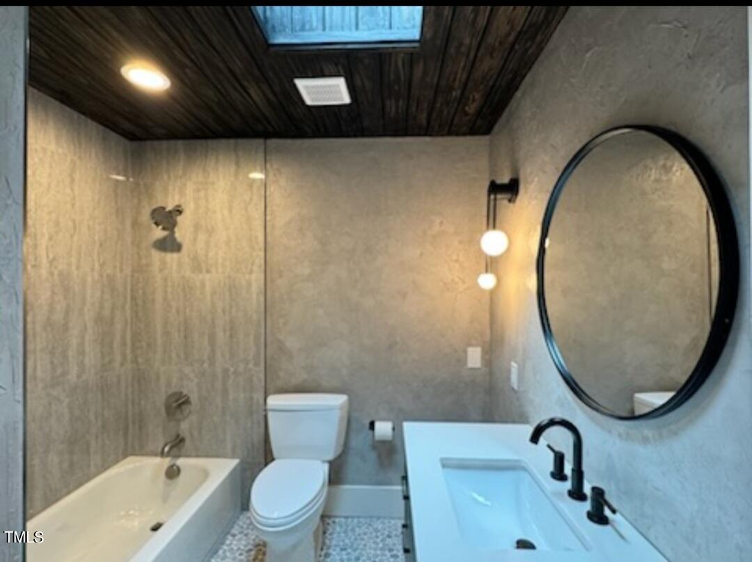 5805 Partridge Lane Raleigh, NC 27609 - Photo 17 of 27 a bathroom with a sink a toilet and a mirror