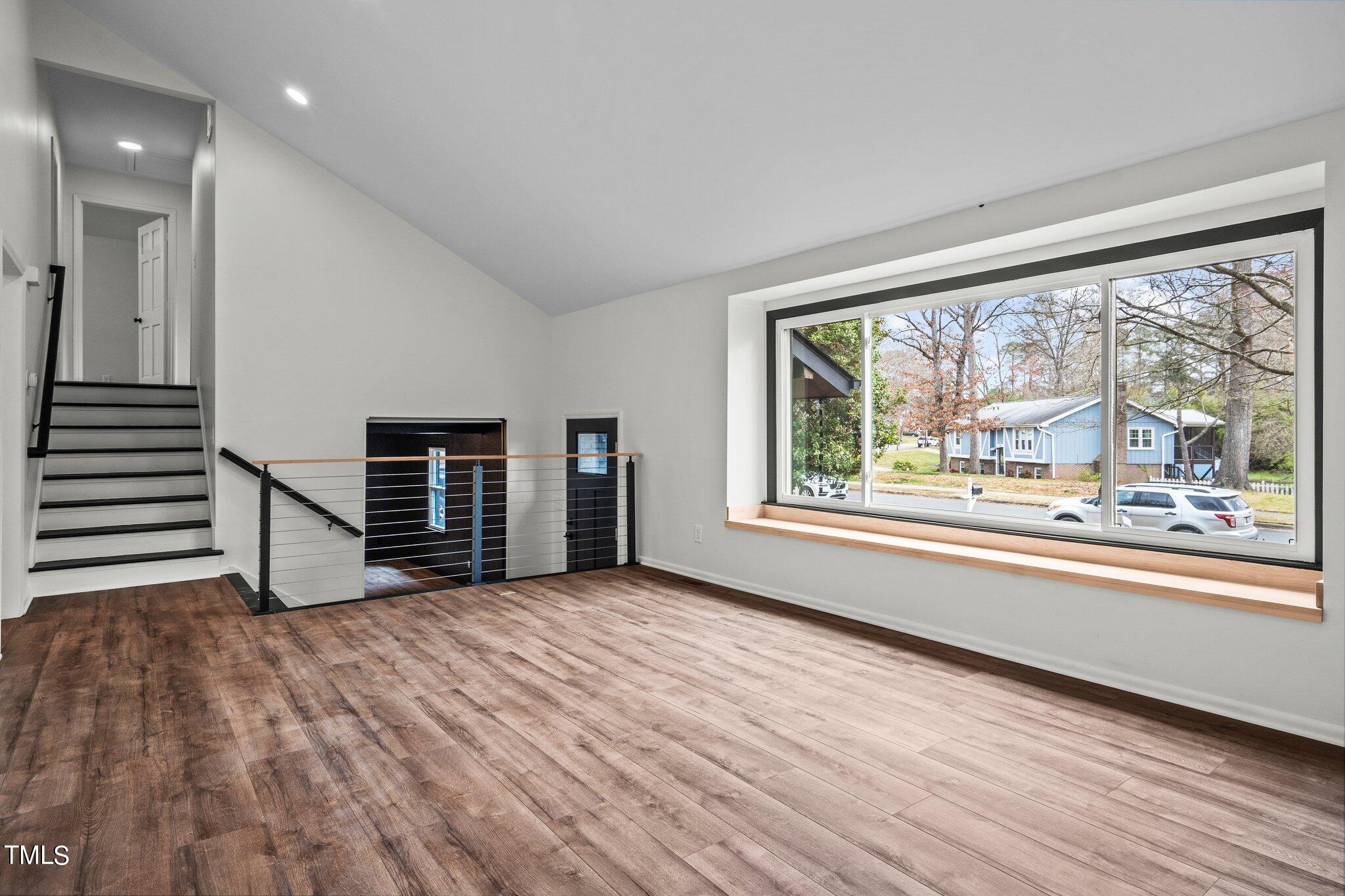 5805 Partridge Lane Raleigh, NC 27609 - Photo 8 of 27 wooden floor in an empty room with a window