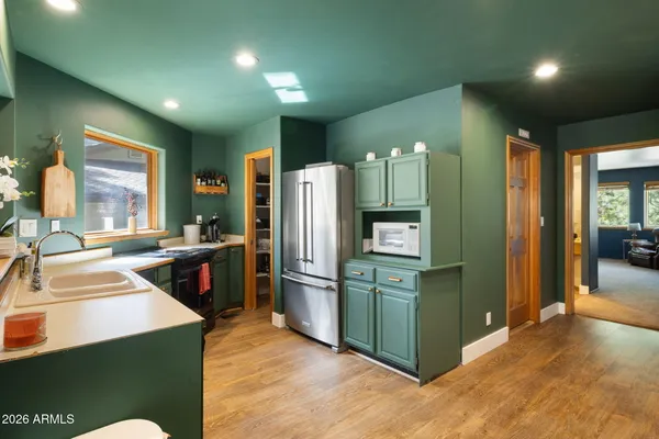 a kitchen with stainless steel appliances granite countertop a refrigerator and a sink