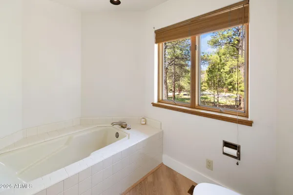 a white bath tub sitting next to a window