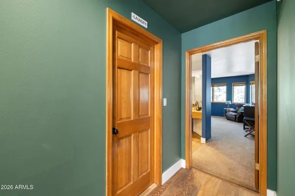 a view of a livingroom and a hall way with furniture