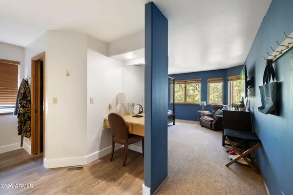 a view of a livingroom with workspace and a window