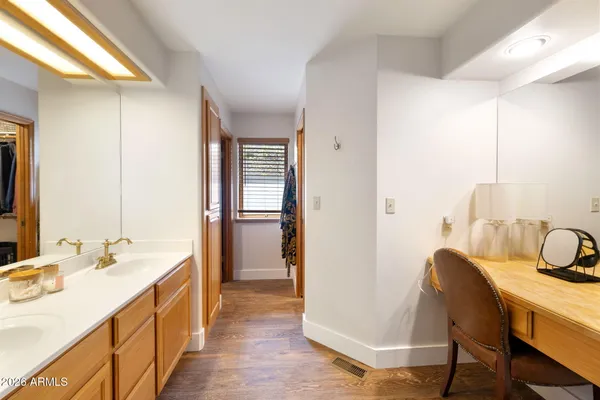 a spacious bathroom with a double vanity sink a mirror and a bathtub