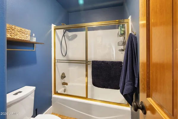 a bathroom with a shower and a toilet