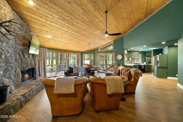 a living room with furniture a fireplace and a large window