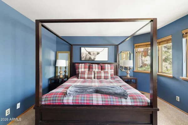 a bedroom with a large bed and a large window