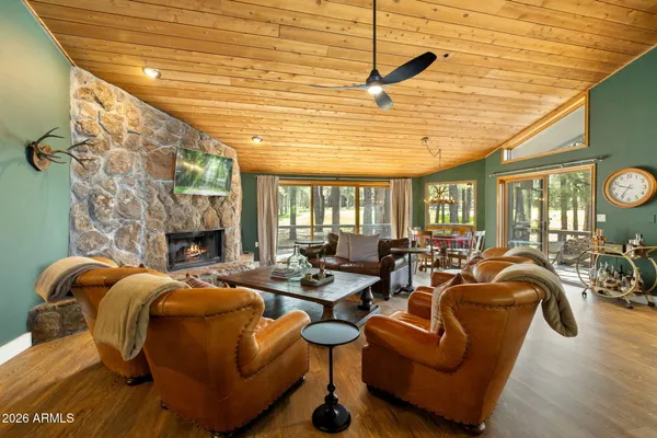 a living room with furniture a fireplace and a table