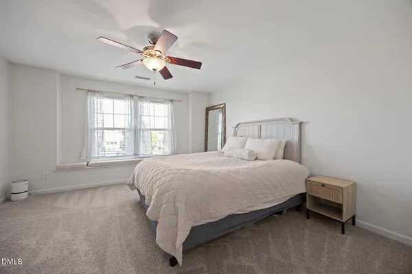a bedroom with a bed and window