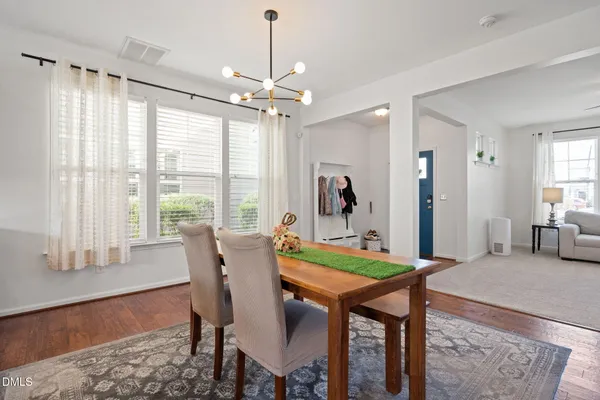 a view of a dining room with furniture window and wooden floor