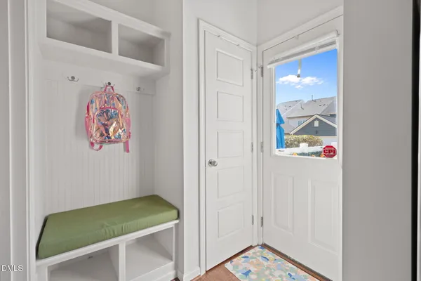 a room with painting on the wall and a potted plant