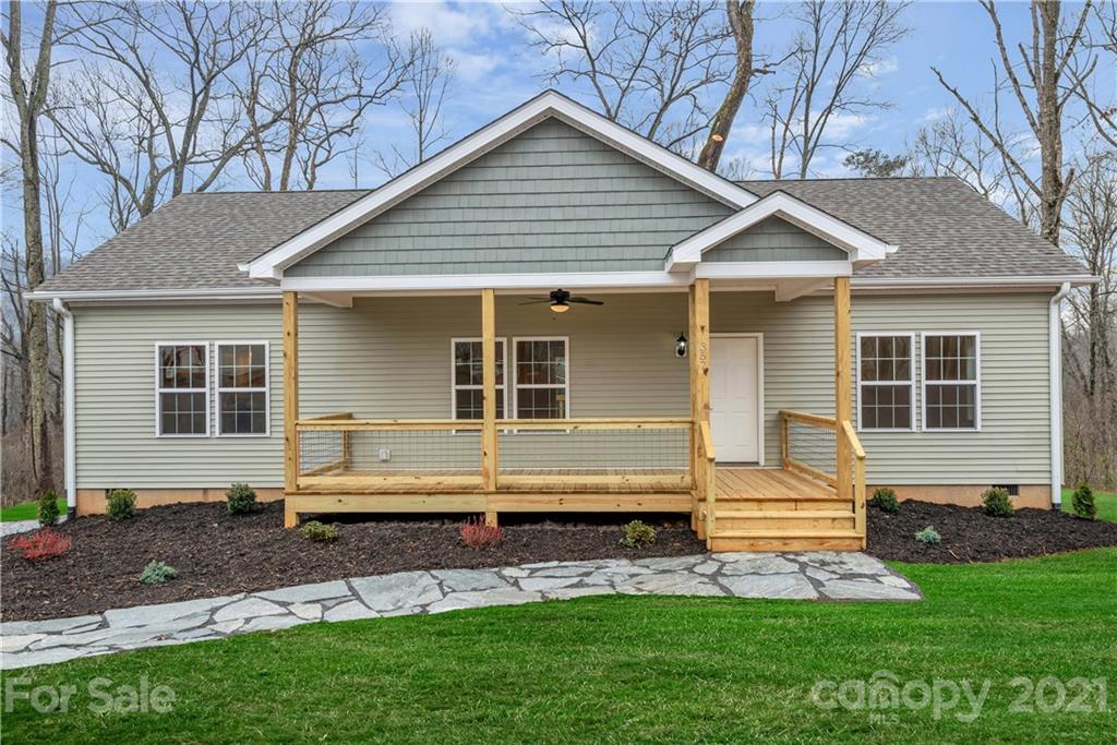 357 Ridge View Drive, Unit 4 Clyde, NC 28721 - Photo 1 of 20 a front view of a house with a yard and outdoor seating