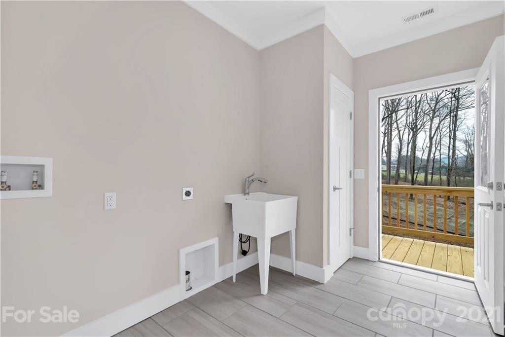 357 Ridge View Drive, Unit 4 Clyde, NC 28721 - Photo 11 of 20 a view of an empty room with wooden floor and a window