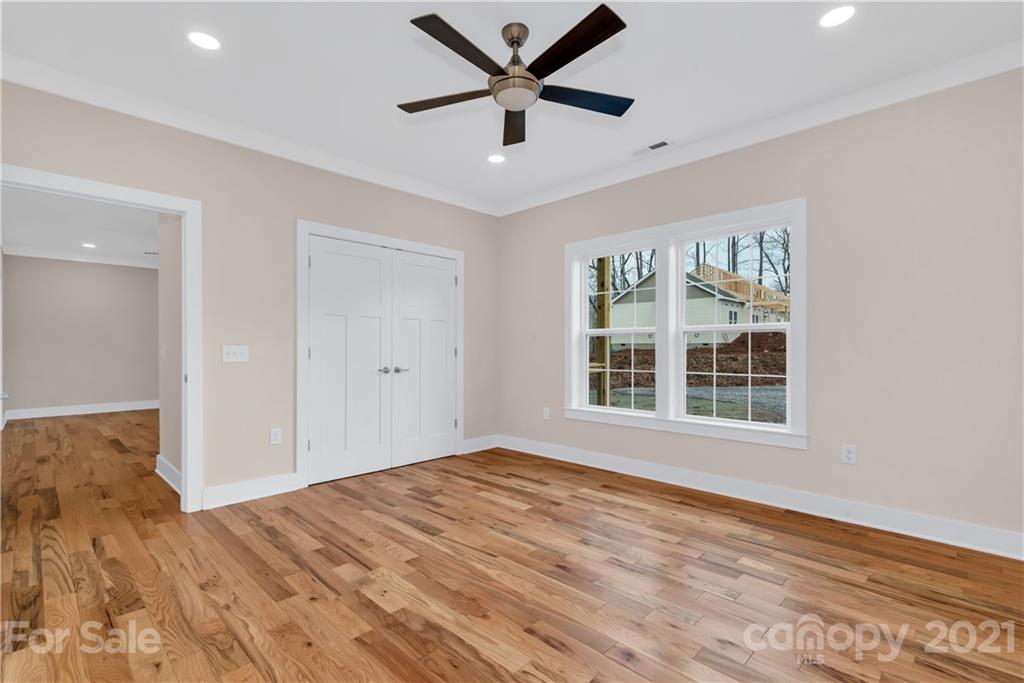 357 Ridge View Drive, Unit 4 Clyde, NC 28721 - Photo 12 of 20 a view of empty room with wooden floor and ceiling fan