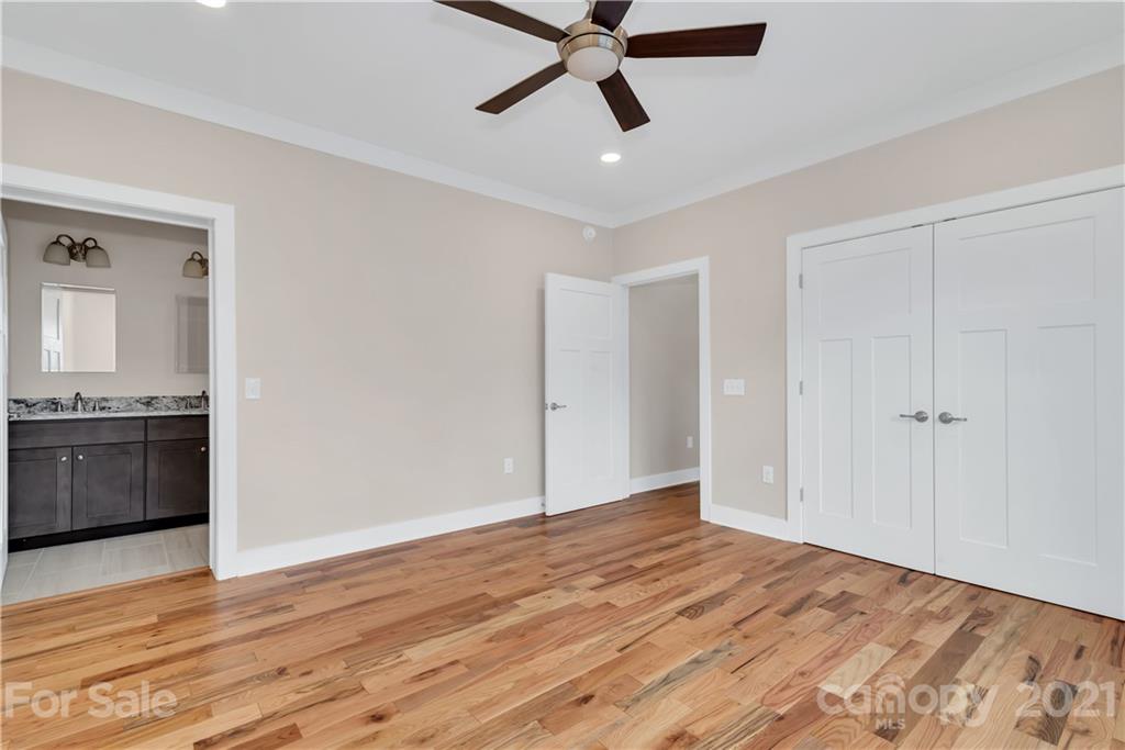 357 Ridge View Drive, Unit 4 Clyde, NC 28721 - Photo 13 of 20 a view of empty room with wooden floor and ceiling fan