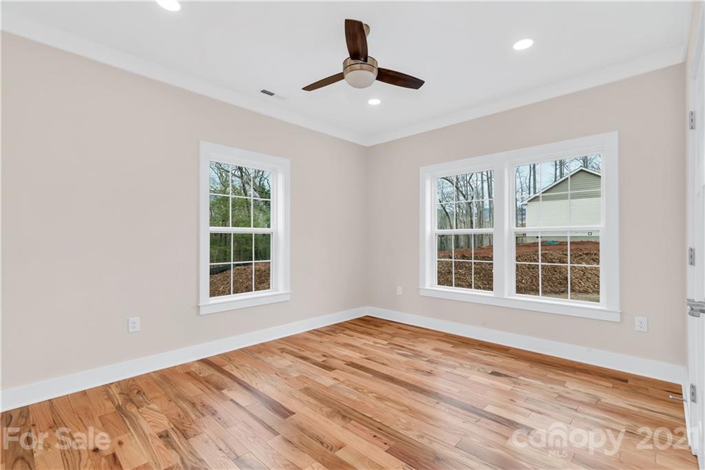 357 Ridge View Drive, Unit 4 Clyde, NC 28721 - Photo 16 of 20 a view of an empty room with a window and wooden floor
