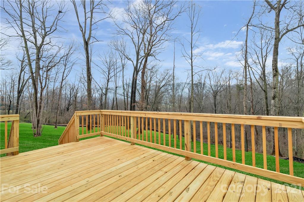 357 Ridge View Drive, Unit 4 Clyde, NC 28721 - Photo 19 of 20 a view of balcony with wooden floor and fence