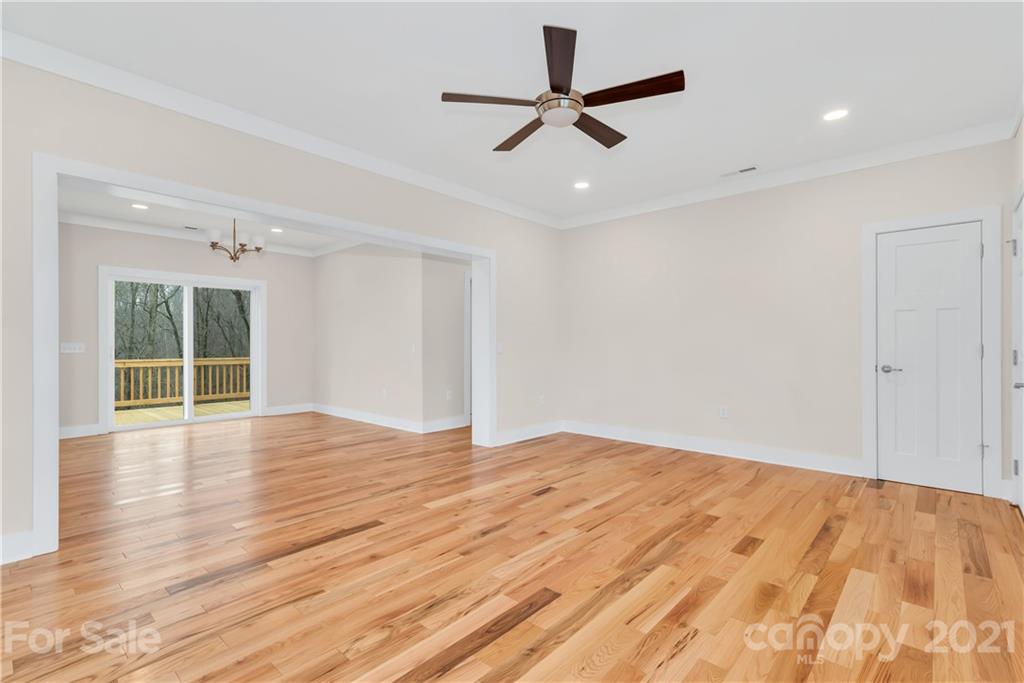 357 Ridge View Drive, Unit 4 Clyde, NC 28721 - Photo 5 of 20 an empty room with wooden floor and windows