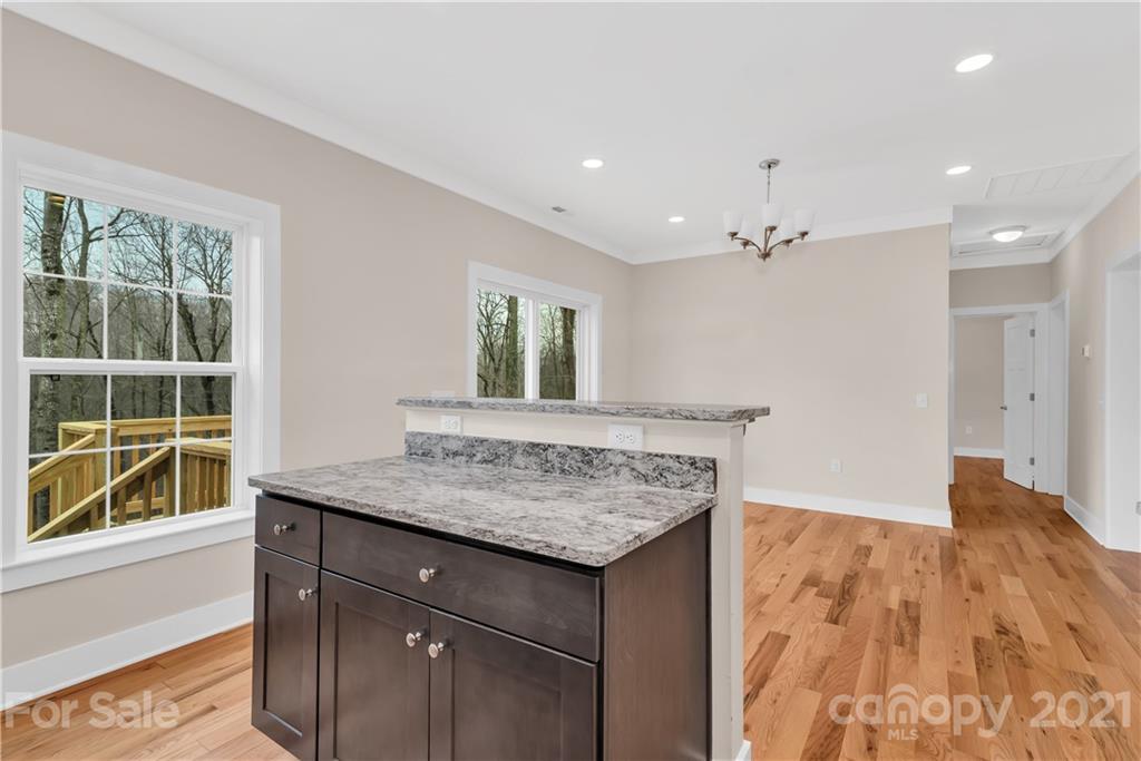 357 Ridge View Drive, Unit 4 Clyde, NC 28721 - Photo 8 of 20 a view of kitchen island with wooden floor