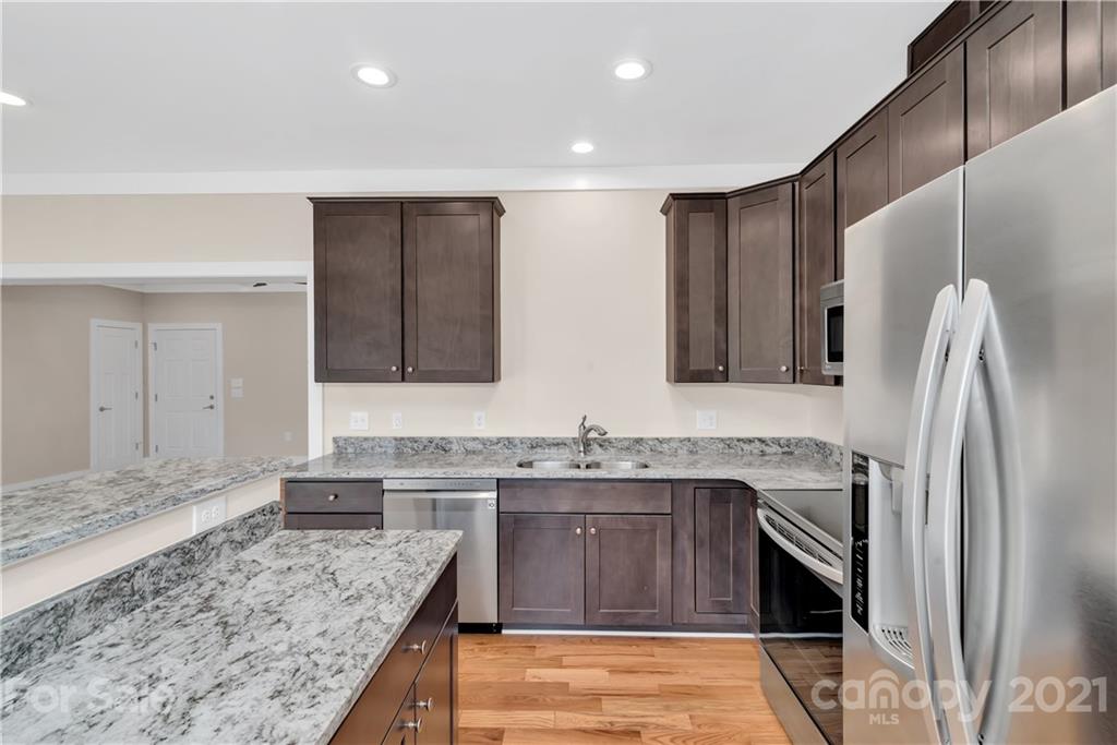 357 Ridge View Drive, Unit 4 Clyde, NC 28721 - Photo 10 of 20 a kitchen with stainless steel appliances granite countertop a sink stove and refrigerator