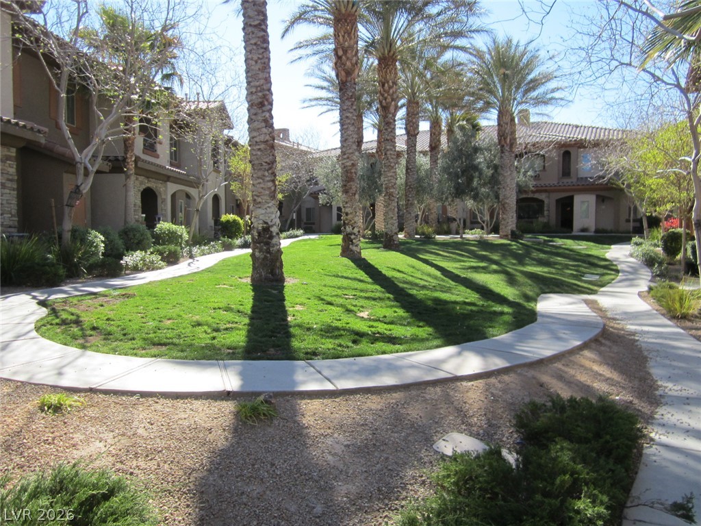 7701 West Robindale Road, Unit 262 Las Vegas, NV 89113 - Photo 5 of 26 Lush green lawns and elegant palm trees grace the front landscaping of this inviting residence.