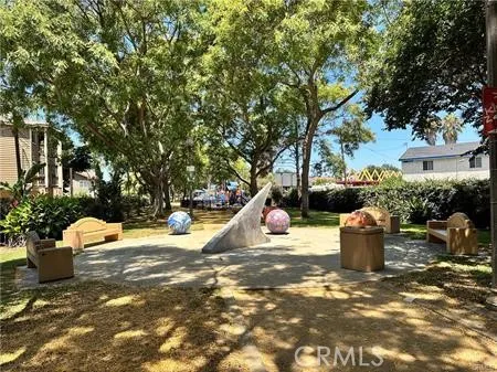 a view of a water fountain and a tree