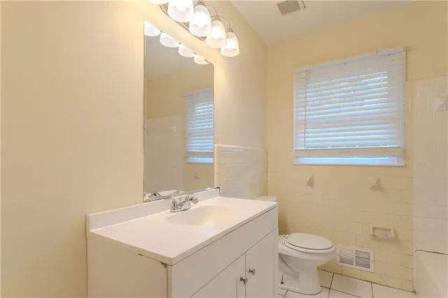 a bathroom with a sink toilet and a mirror
