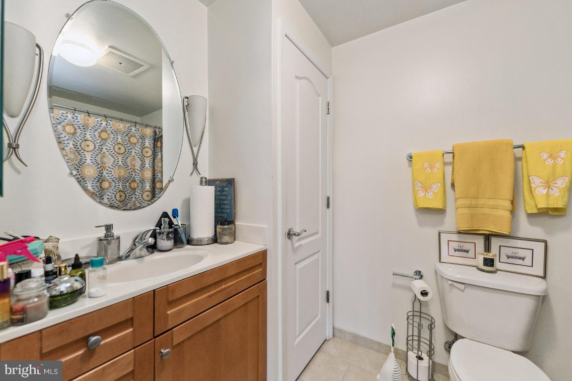 1111 11th Street Northwest, Unit 408 Washington, DC 20001 - Photo 13 of 21 a bathroom with a toilet sink and mirror