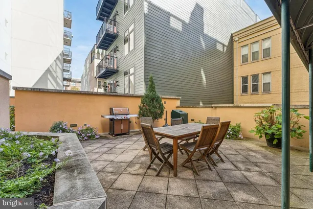 a backyard of a house with lots of green space and outdoor seating