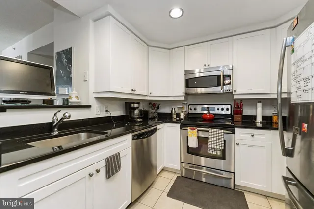 a kitchen with stainless steel appliances granite countertop a stove and a sink