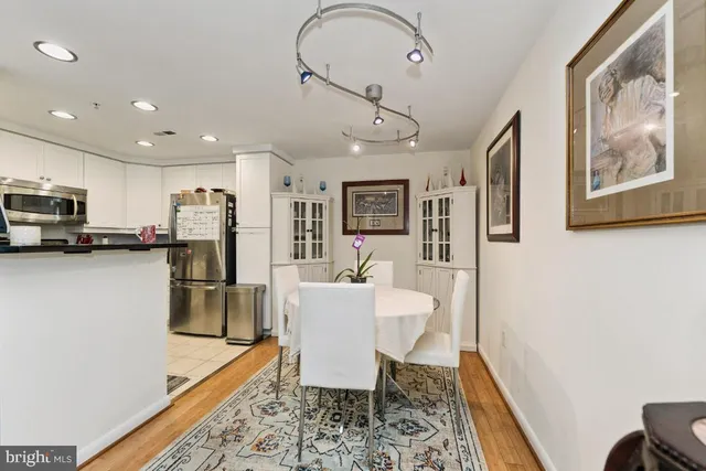 a living room with furniture a flat screen tv and kitchen view