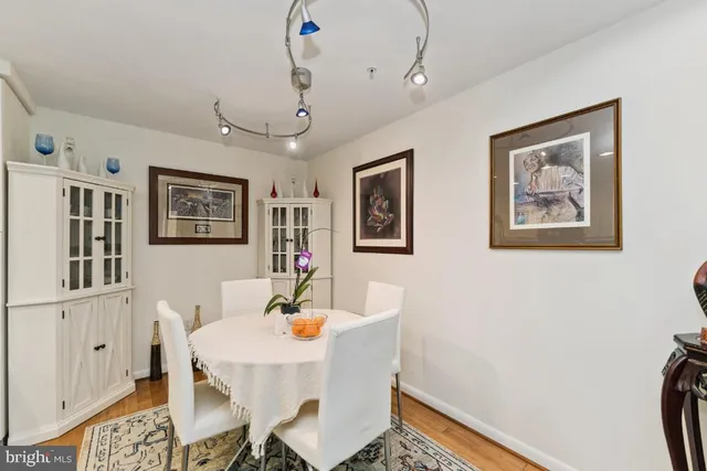 a view of a dining room with furniture and a chandelier fan